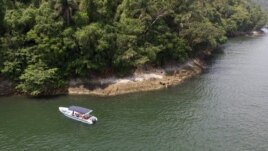 A boat belonging to Animal Heart Protectors is anchored off Furtada Island, popularly known as “Island of the Cats,” where they deliver food and water to the cats in Mangaratiba, Brazil, Tuesday, Oct. 13, 2020. (AP Photo/Mario Lobao)