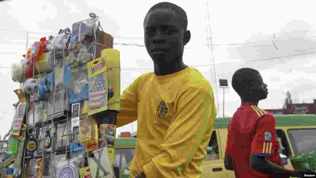 A boy displays his wares for sale along a road near the central market in Nigeria's northern city of Kaduna.