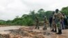 Des soldats inspectent les dégâts sur une route à la suite d'inondations et de glissements de terrain provoqués par le cyclone Idai à Chimanimani, au Zimbabwe, le 18 mars 2019.