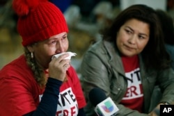 El Salvador immigrants Diana Paredes, left, and Isabel Barrera react at a news conference following an announcement on Temporary Protected Status for nationals of El Salvador, in Los Angeles, Jan. 8, 2018.