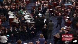 In this image from video provided by C-SPAN2, Sen. John McCain, R-Ariz. is applauded as he arrives of the floor of the Senate on Capitol Hill in Washington, July 25, 2017.