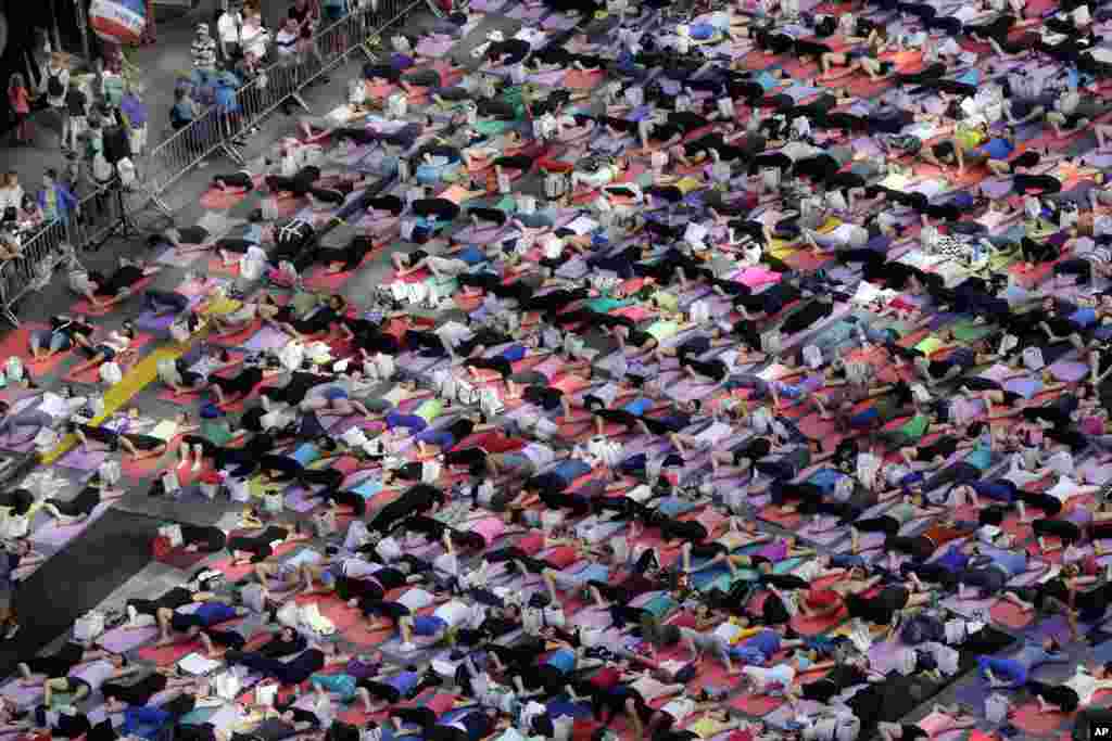 Thousands of New Yorkers are marking the first day of summer by practicing yoga in Times Square, during the 12th annual Solstice in Times Square, sponsored by the Times Square Alliance and Athleta, Gap Inc.&#39;s exercise-wear brand, June 21, 2014.