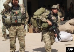 Afghan special forces arrive at the airport as they launch a counteroffensive to retake the city from Taliban insurgents, in Kunduz, Sept. 29, 2015.