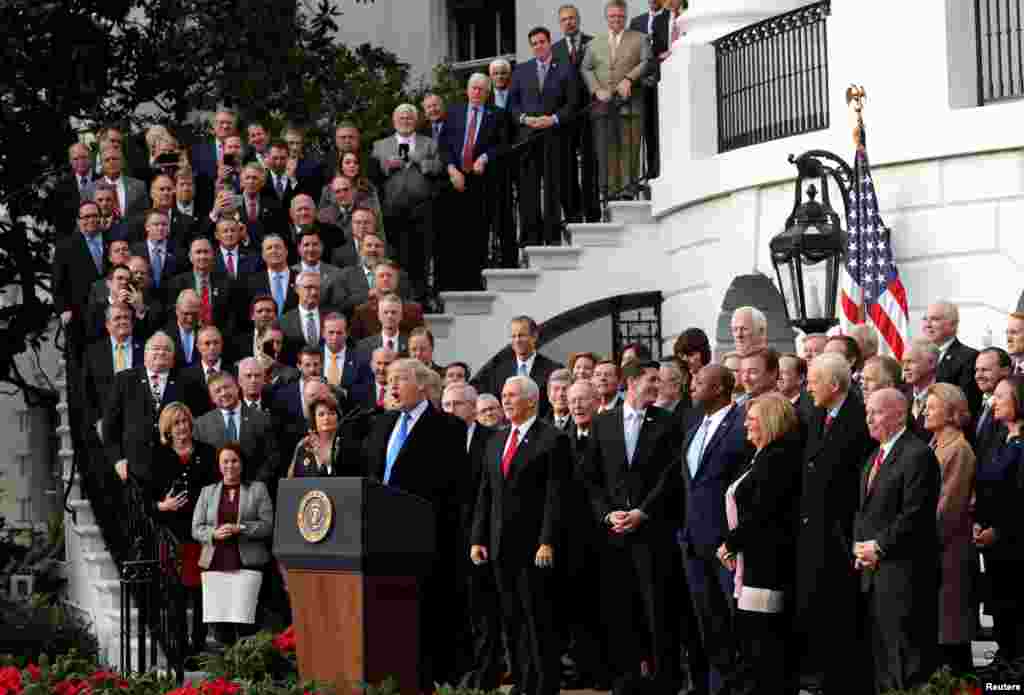 U.S. President Donald Trump celebrates with Congressional Republicans after the U.S. Congress passed sweeping tax overhaul legislation, on the South Lawn of the White House in Washington, D.C.