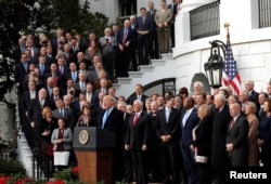 U.S. President Donald Trump celebrates with Congressional Republicans after the U.S. Congress passed sweeping tax overhaul legislation, on the South Lawn of the White House in Washington, Dec. 20, 2017.