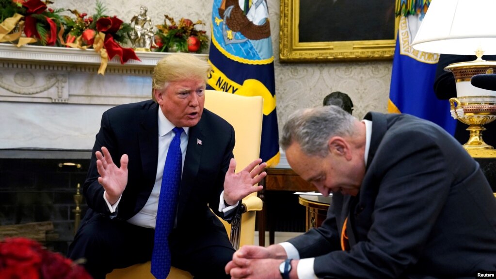 U.S. President Donald Trump speaks with Senate Democratic Leader Chuck Schumer (D-NY) in the Oval Office of the White House in Washington, Dec. 11, 2018.