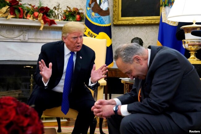U.S. President Donald Trump speaks with Senate Democratic Leader Chuck Schumer (D-NY) in the Oval Office of the White House in Washington, Dec. 11, 2018.