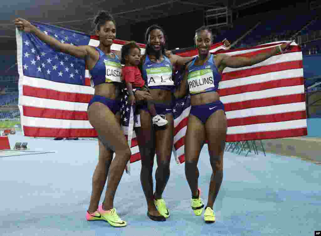 Gold medal winner Brianna Rollins, silver medal winner, Nia Ali, and bronze medal winner Kristi Castlin,all from the United States, celebrate with their country's flag.