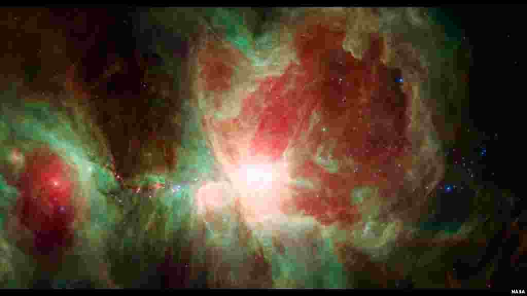 The Orion Nebula, an immense stellar nursery some 1,500 light-years away. This stunning false-color view spans about 40 light-years across the region, constructed using infrared data from the Spitzer Space Telescope.