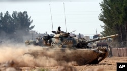 Turkish tanks head towards the Syrian border, in Karkamis, Turkey, Aug. 31, 2016. 