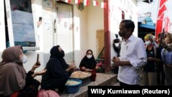 Presiden Joko Widodo berbincang dengan para warga dalam kunjungannya ke Tarakan, Kalimantan Utara, untuk mengecek program vaksinasi di wilayah tersebut pada 19 Oktober 2021. (Foto: Reuters/Willy Kurniawan)