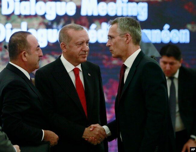 Turkey's President Recep Tayyip Erdogan, center, and Foreign Minister Mevlut Cavusoglu, left, speak with NATO Secretary General Jens Stoltenberg during a NATO's Mediterranean Dialogue, in Ankara, Turkey, Monday, May 6, 2019.