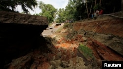 A view of a portion of a damaged highway in Getafe, Bohol, a day after an earthquake hit central Philippines, Oct. 16, 2013.