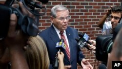 FILE - Sen. Robert Menendez, D-N.J., answers a reporter's question in Union Township, N.J.