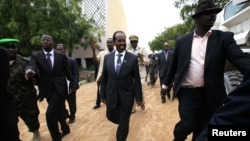 Somalia's new president Hassan Sheikh Mohamud (C) is escorted as he attends his inauguration ceremony in Mogadishu September 16, 2012.