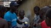 FILE - A UNICEF worker shares information on Ebola and how to help prevent its spread in Conakry, Guinea in this UNICEF handout photo.