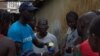 FILE - A UNICEF worker shares information on Ebola and how to help prevent its spread in Conakry, Guinea in this UNICEF handout photo.
