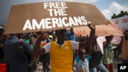 People protest for the release of kidnapped missionaries near the missionaries' headquarters in Titanyen, north of Port-au-Prince, Haiti, Oct. 19, 2021.