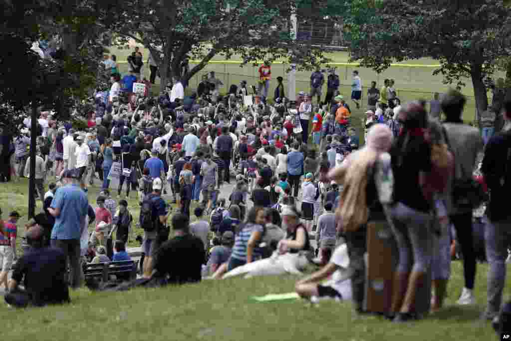 People assemble on Boston Common before a planned "Free Speech" rally by conservative organizers begins, Aug. 19, 2017, in Boston. 