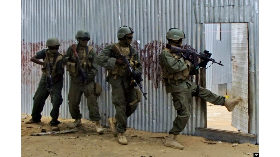 FILE - Somali soldiers search through homes for al-Shabab fighters, during an operation in Ealsha Biyaha, Somalia, June, 2, 2012.