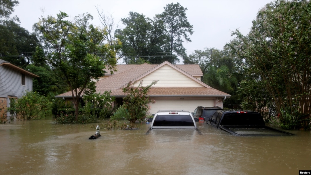 Floodwaters from tropical storm Harvey partially submerge houses and cars in east Houston, Texas, Aug. 28, 2017. 