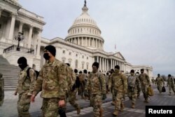 Members of the National Guard arrive to the U.S. Capitol days after supporters of U.S. President Donald Trump stormed the Capitol in Washington, Jan. 11, 2021.
