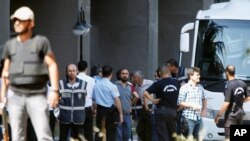 FILE - Military personnel, suspected of being involved in the coup attempt, are escorted by policemen as they arrive at the Justice Palace in Ankara, Turkey, July 18, 2016.