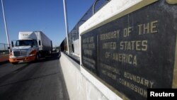 FILE - Trucks wait in the queue for border customs control to cross into the U.S., at the Bridge of the Americas, in Ciudad Juarez, Mexico, Aug. 15, 2017.