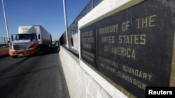 FILE - Trucks wait in the queue for border customs control to cross into U.S. at the Bridge of Americas, in Ciudad Juarez, Mexico, Aug. 15, 2017.