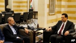 Lebanese Prime Minister Hassan Diab, right, meets with Iranian Parliament Speaker Ali Larijani, in Beirut, Lebanon, Feb. 17, 2020. 
