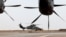 FILE - A French Eurocopter Tiger (Eurocopter EC665 Tigre) helicopter (L) takes off at the French Military base in Gao, Mali, Dec. 5, 2021.