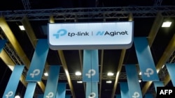 FILE - A view of the logos of TP-Link, a maker of computer networking products, and its sub-brand Aginet, whose products are designed for internet service providers, at the Mobile World Congress in Barcelona, Spain, Feb. 28, 2023.