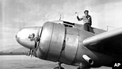 A March 10, 1937 photo of American aviator Amelia Earhart waving from the Electra before taking off from Los Angeles, California.