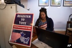Le'Ana Freeman from Washington registers before casting vote on the Super Tuesday for U.S. Democrats Abroad multi-location global primary, at Foreign Correspondents' Club of Thailand in Bangkok, March 3, 2020.