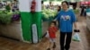 FILE - Customers shop for grocery at a morning market in Beijing, Aug. 9, 2023. 