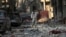 A Free Syrian Army fighter talks on a mobile phone as he stands on the rubble of damaged buildings in Deir al-Zor, eastern Syria, Nov. 12, 2013. 