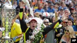Simon Pagenaud, of France, celebrates after winning the Indianapolis 500 IndyCar auto race at Indianapolis Motor Speedway, Sunday, May 26, 2019, in Indianapolis.