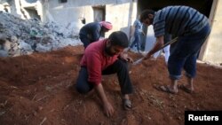 FILE - Residents grow their own vegetables near the rubble of damaged buildings in the rebel held area of al-Jazmati neighborhood of Aleppo, Syria April 22, 2016. 