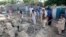 Earthquake survivors stand on the rubble of a mud house after it collapsed in Jalalabad, Afghanistan, April 24, 2013. 