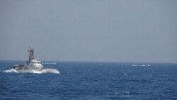 Two Iranian Islamic Revolutionary Guard Corps attack craft operate near the U.S. Coast Guard cutter Maui as it transits the Strait of Hormuz, May 10, 2021. (U.S. Navy photo)