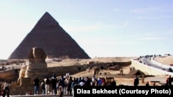 FILE - Tourists are gathering around the Sphinx, which guards the Great Pyramid of King Cheops at the Giza necropolis just outside Cairo, Egypt. (photo: Diaa Bekheet)