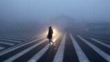 A woman walks along a street during a smoggy day in Changchun, Jilin province. The severe smog continued to shroud major cities in north-east China including Changchun.