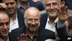 FILE - In this May 28, 2020, photo, Mohammad Bagher Qalibaf, center, is surrounded by a group of lawmakers after being elected as speaker of the parliament, in Tehran, Iran.