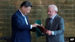 China's President Xi Jinping, left, and Brazil's President Luiz Inacio Lula da Silva attend a bilateral agreement signing ceremony, at the Alvorada palace in Brasilia, Brazil, Nov. 20, 2024.