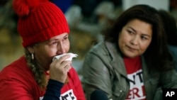 FILE - El Salvador immigrants Diana Paredes, left, and Isabel Barrera react at a news conference following an announcement on Temporary Protected Status for nationals of El Salvador, in Los Angeles, Jan. 8, 2018.