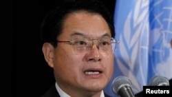 FILE - Director General of the United Nations Industrial Development Organization (UNIDO) Li Yong (L) speaks to the media following a meeting at the United Nations headquarters in New York, Sept. 23, 2013. 