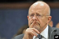 FILE - Then-Director of National Security James Clapper testifies before the House Intelligence Committee on Capitol Hill in Washington, Feb. 2, 2012.