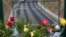 Flowers sit on a bridge above the railway tracks at the spot of a train crash in Santiago de Compostela, Spain, July 27, 2013.