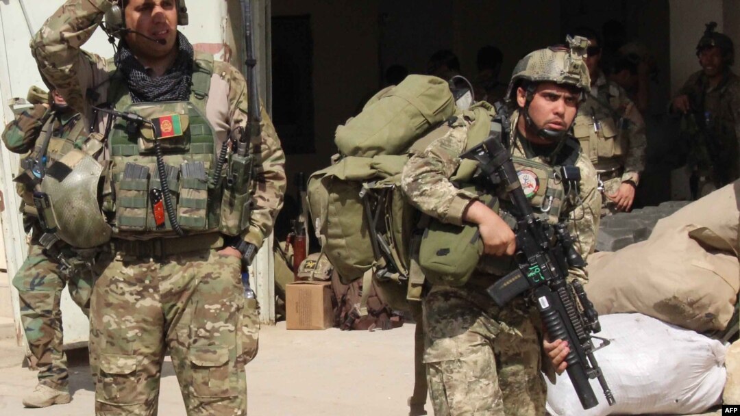 FILE - Afghan special forces arrive at the airport as they launch a counteroffensive to retake the city from Taliban insurgents, in Kunduz, Sept. 29, 2015. 