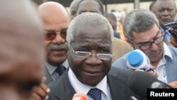 FILE - Renamo's Afonso Dhlakama speaks to reporters after voting in general elections in Maputo, Mozambique, Oct. 15, 2014. 
